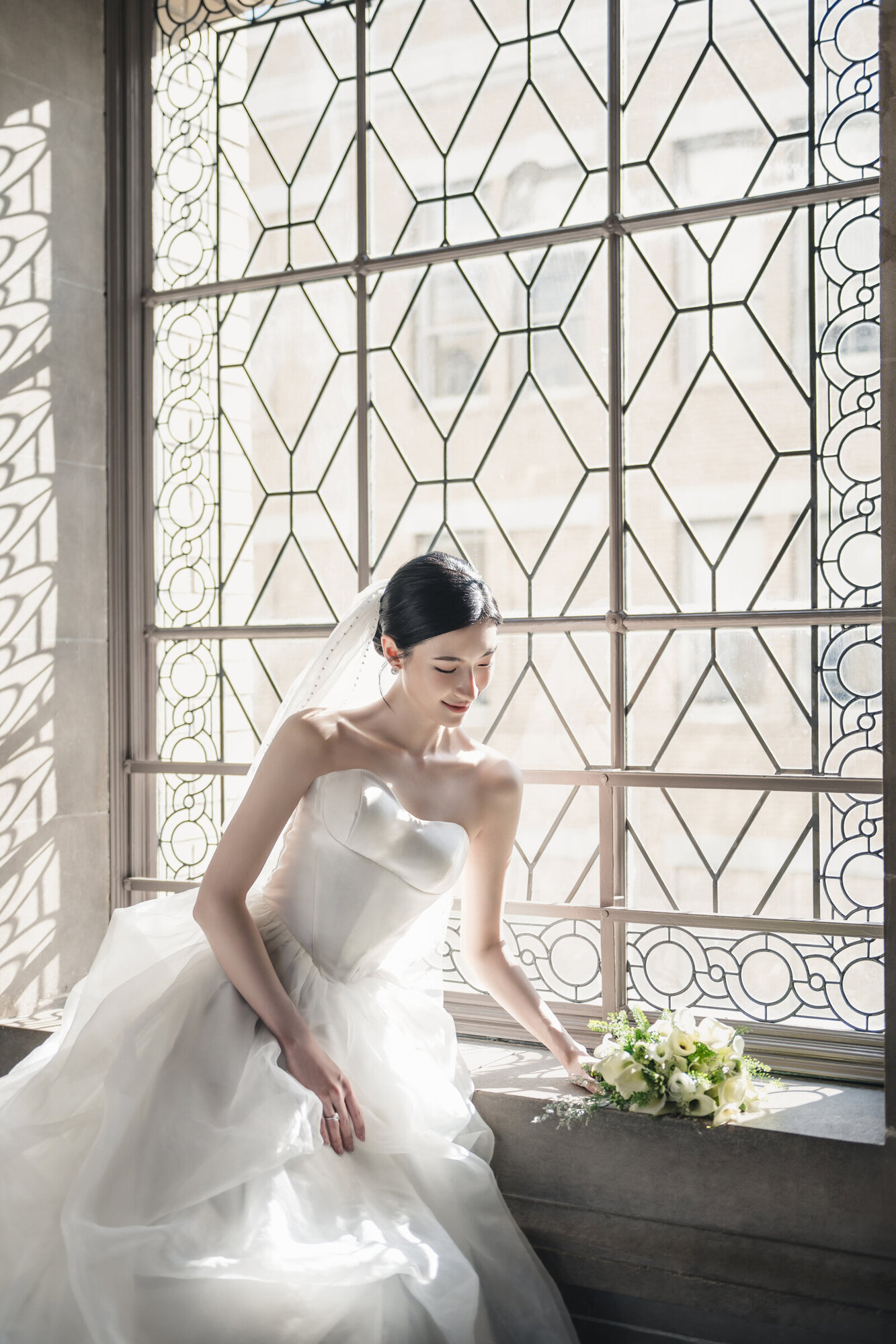 Seated bridal portrait by the City Hall window