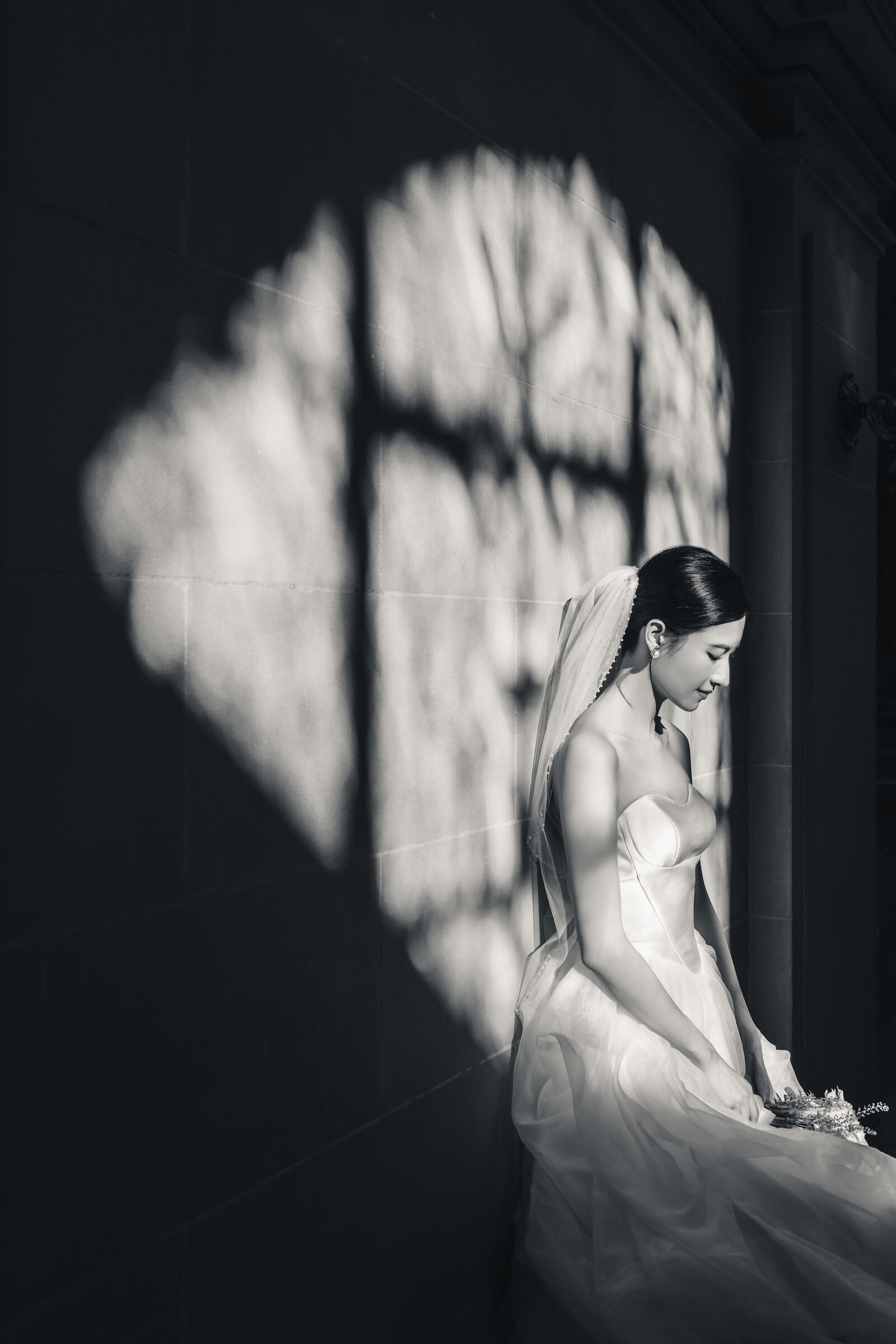 Bridal portrait framed by graphic window shadow