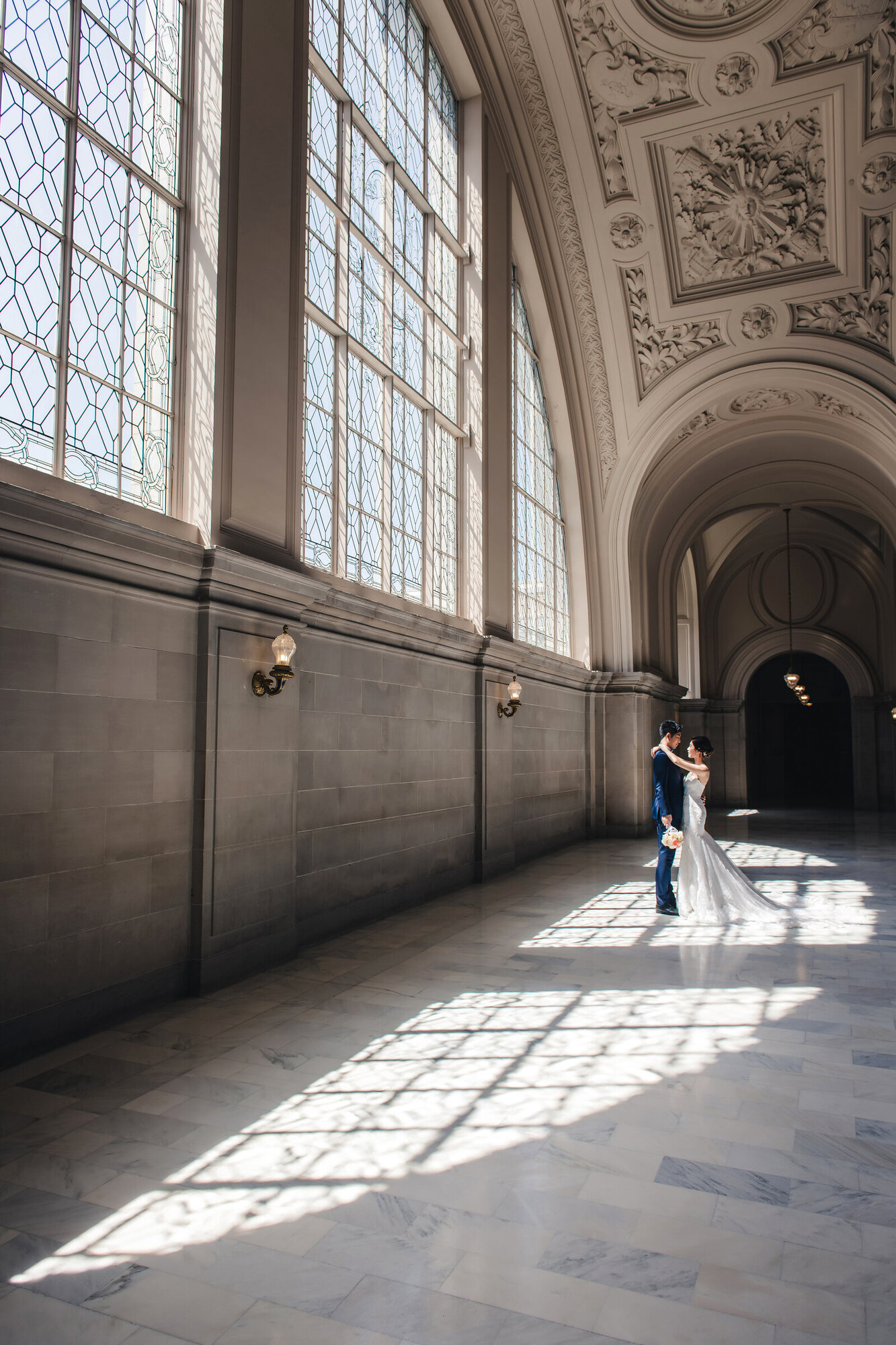 Environmental couple portrait in City Hall hallway light