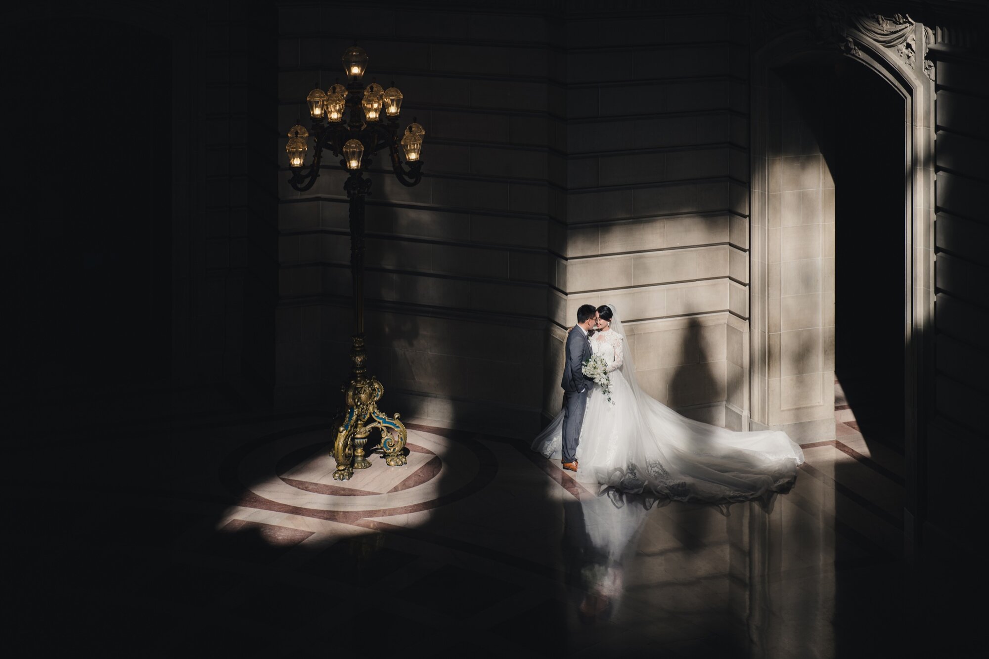 Cinematic City Hall wedding portrait in dramatic lamp light