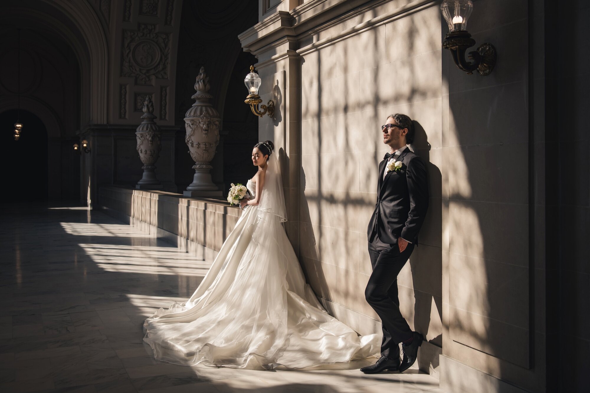 Sunlit City Hall wedding portrait with architectural shadows