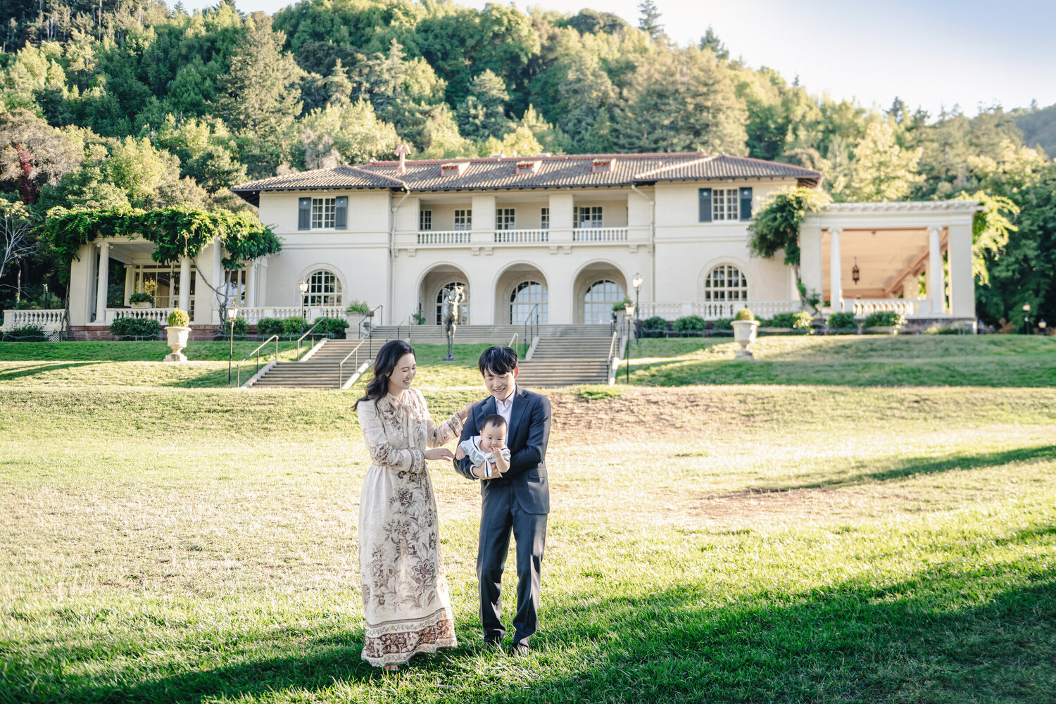 Environmental family portrait in front of an estate