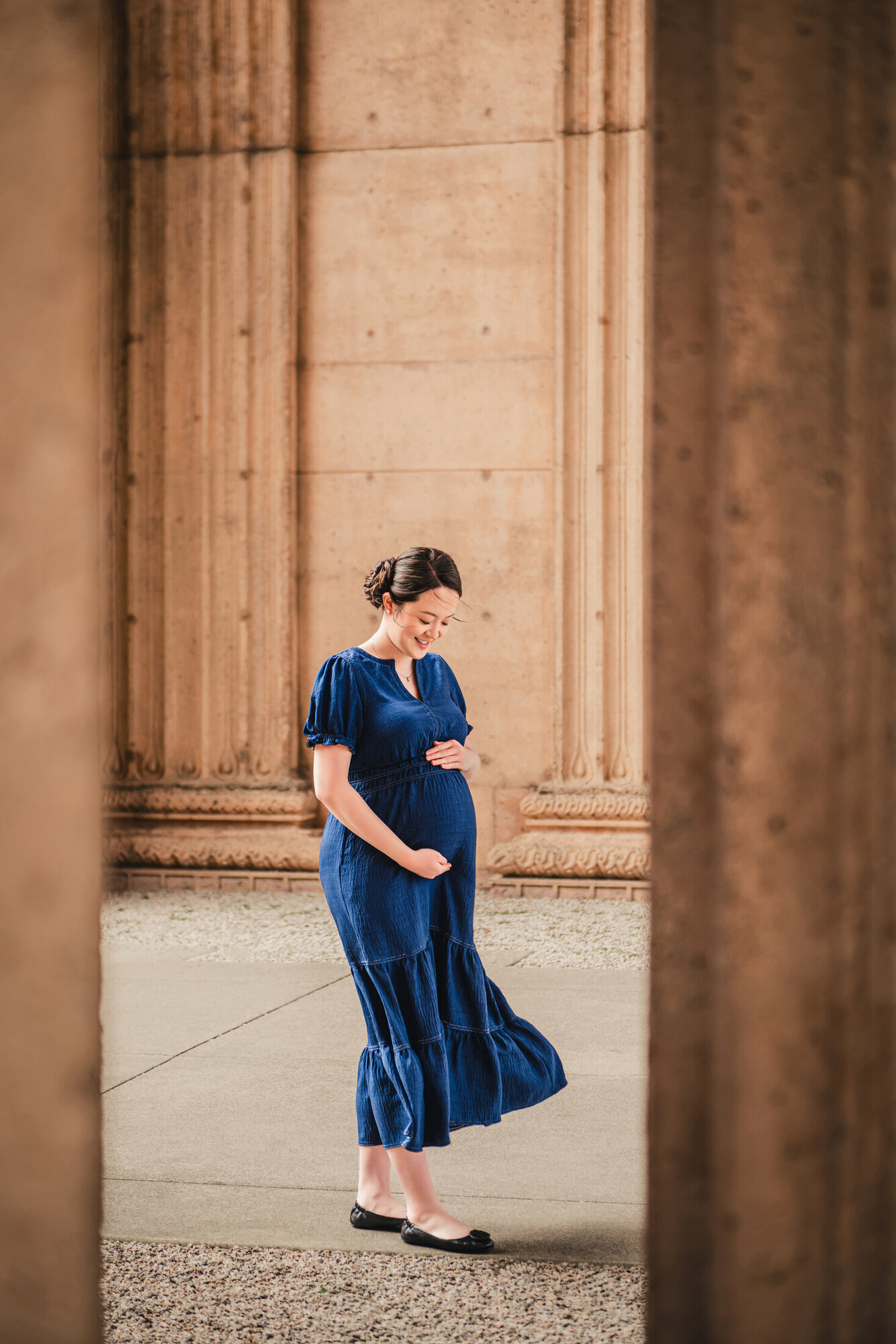 Maternity portrait framed by architectural columns