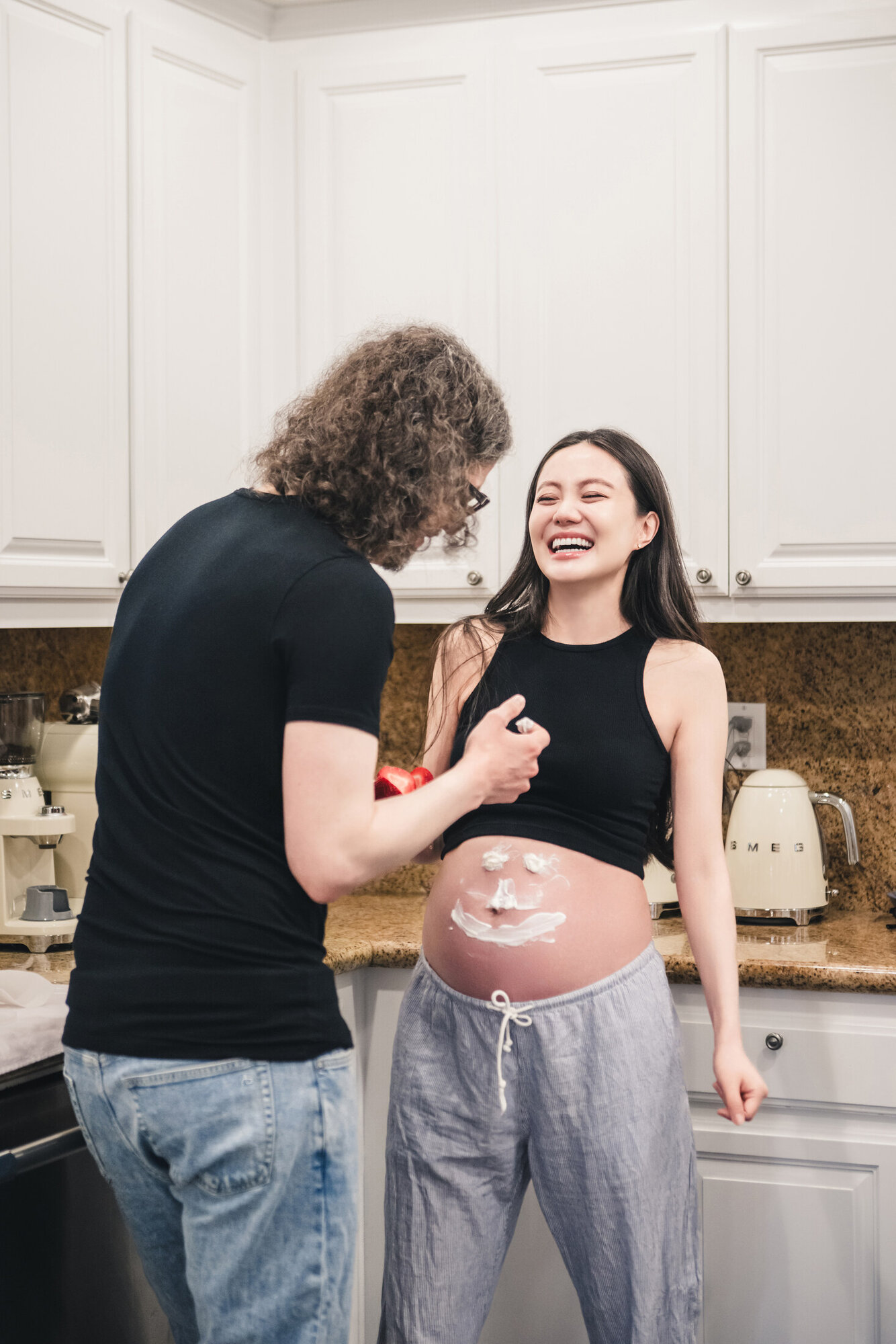 Lifestyle maternity photograph with laughter at home