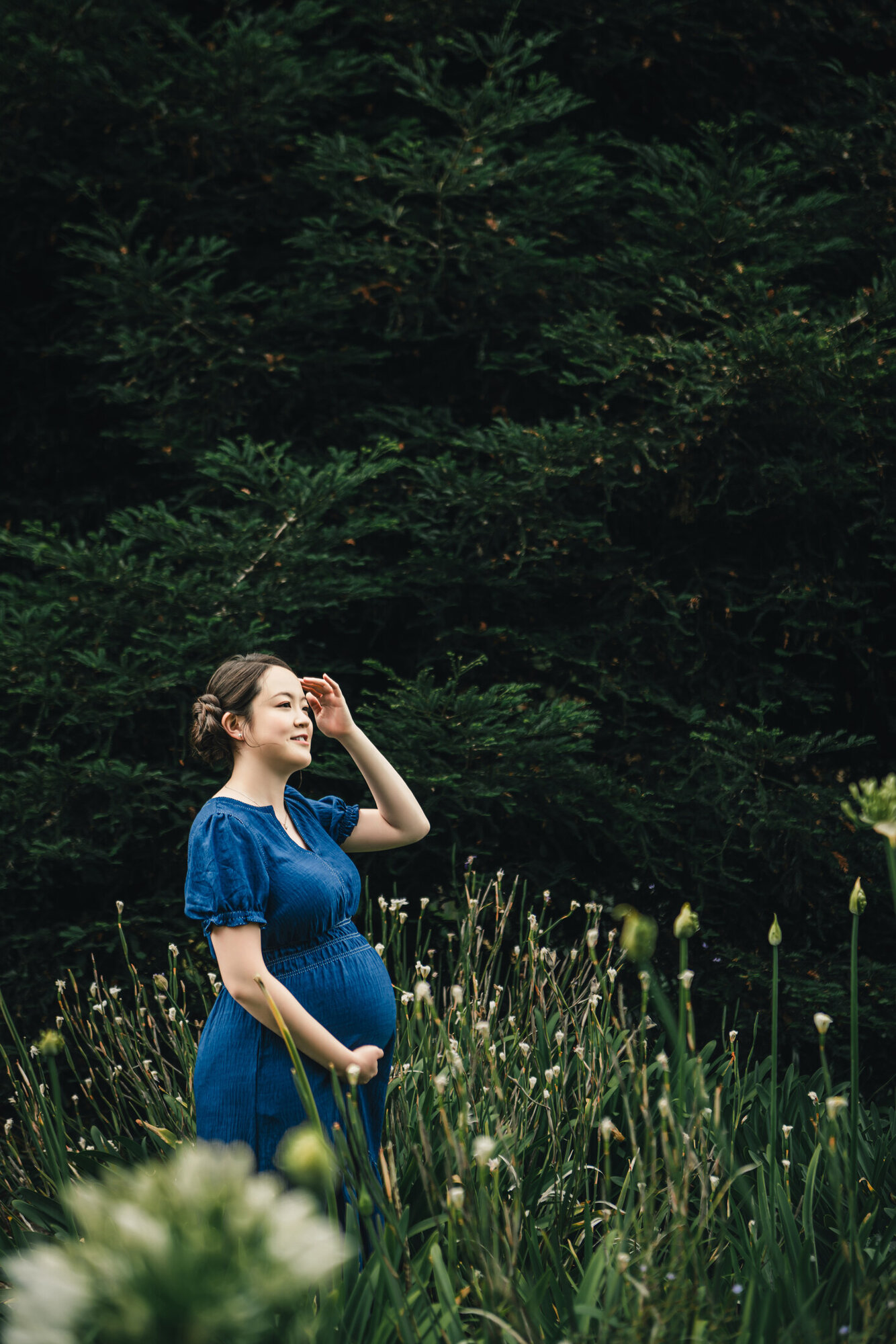Garden maternity portrait surrounded by greenery