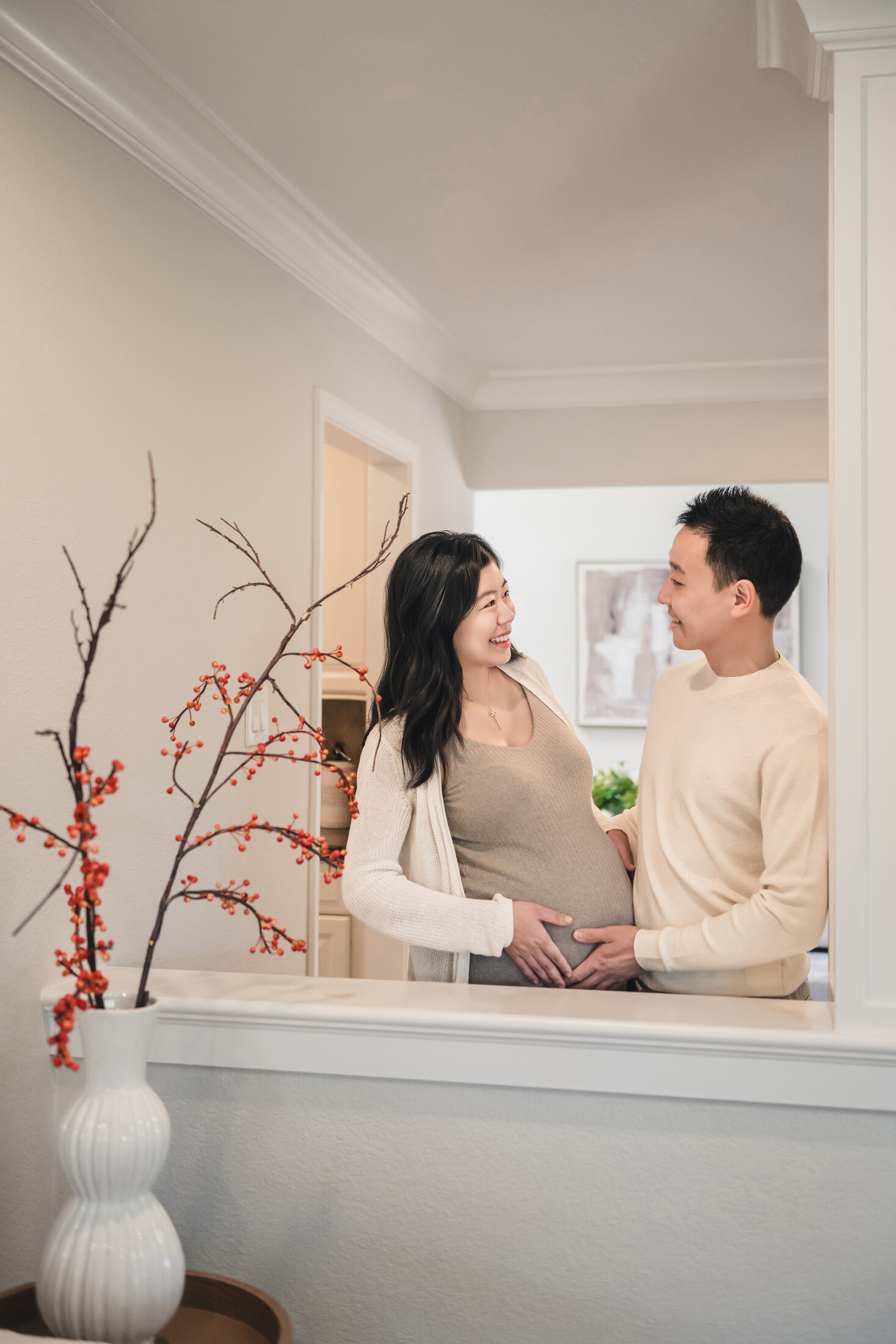 Maternity couple portrait by a bright window