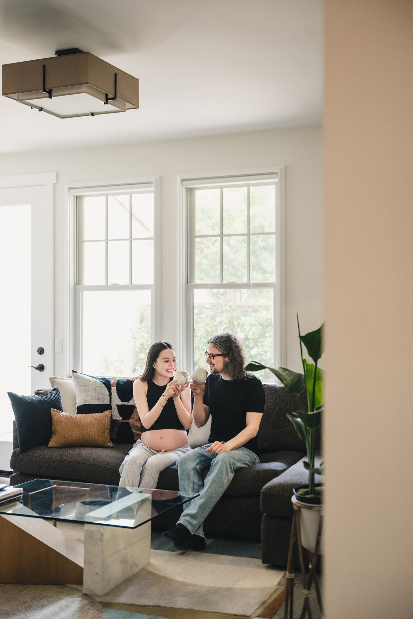 Wide lifestyle maternity portrait in the living room