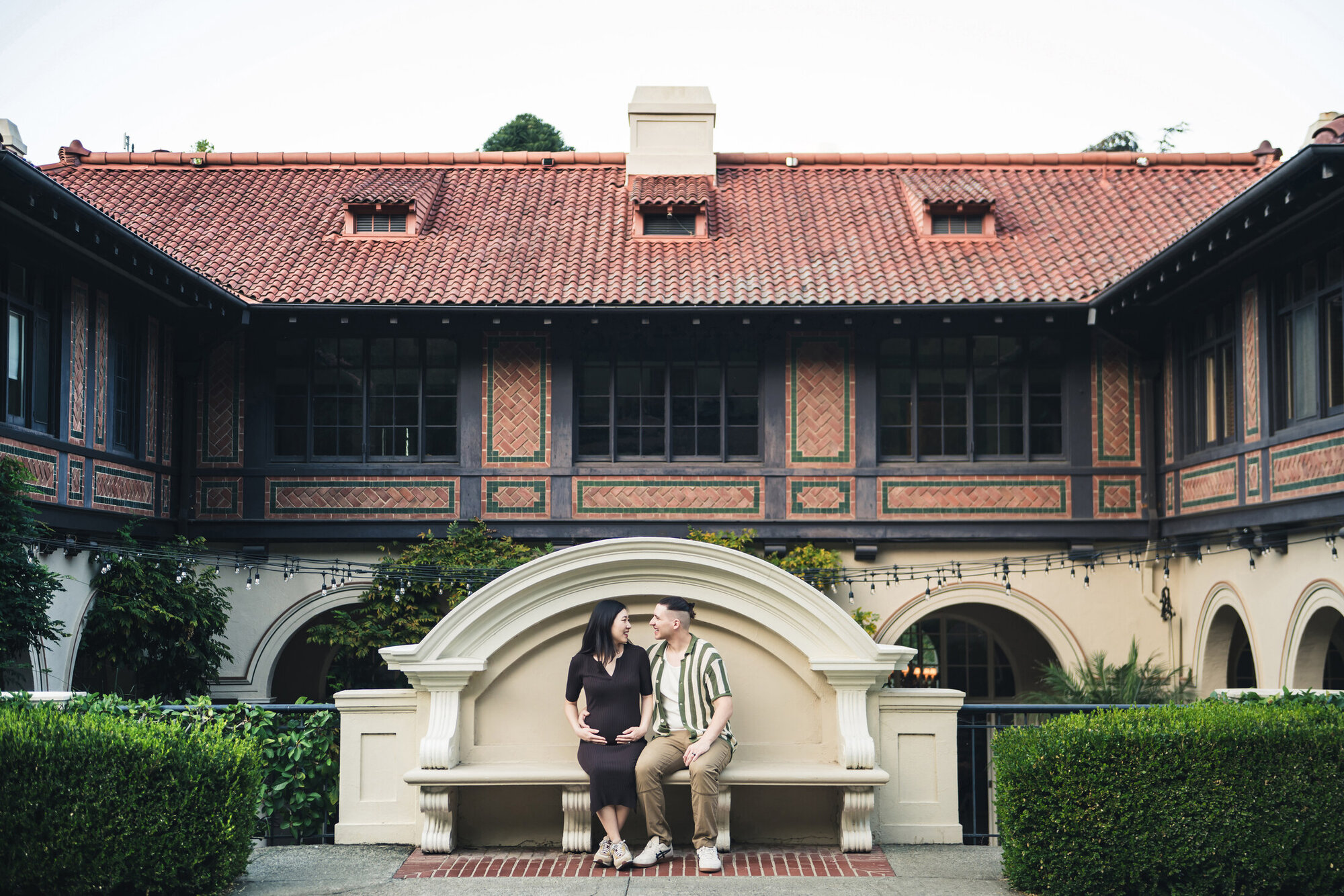 Wide architectural maternity portrait with a strong sense of place