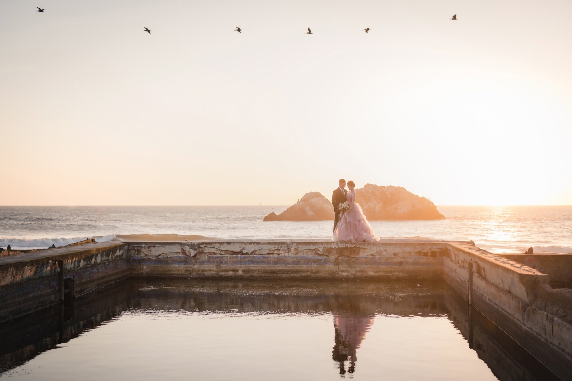 Coastal pre-wedding portrait with birds