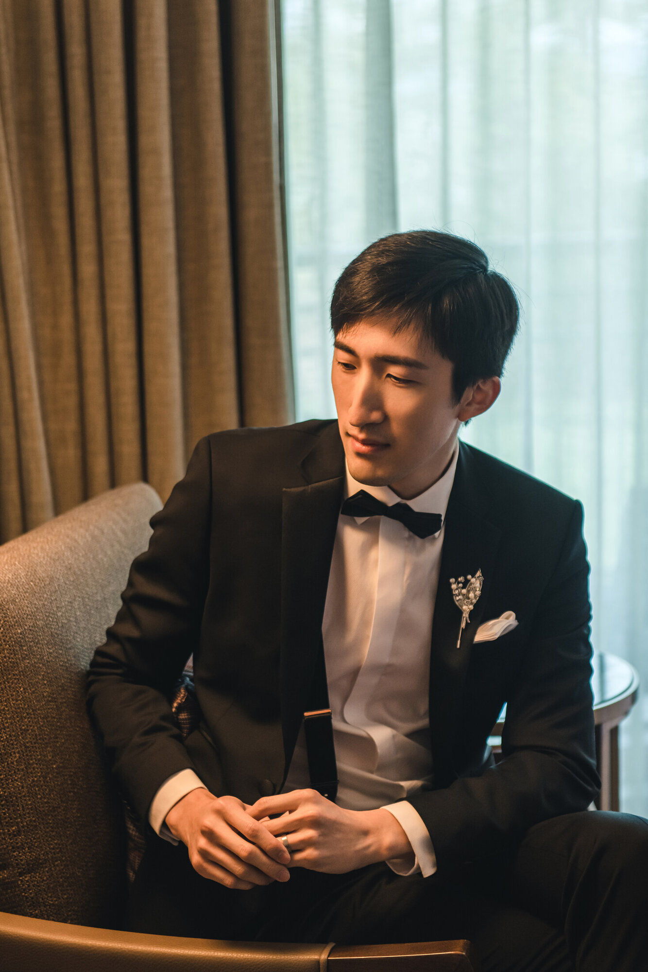 Groom portrait by the window