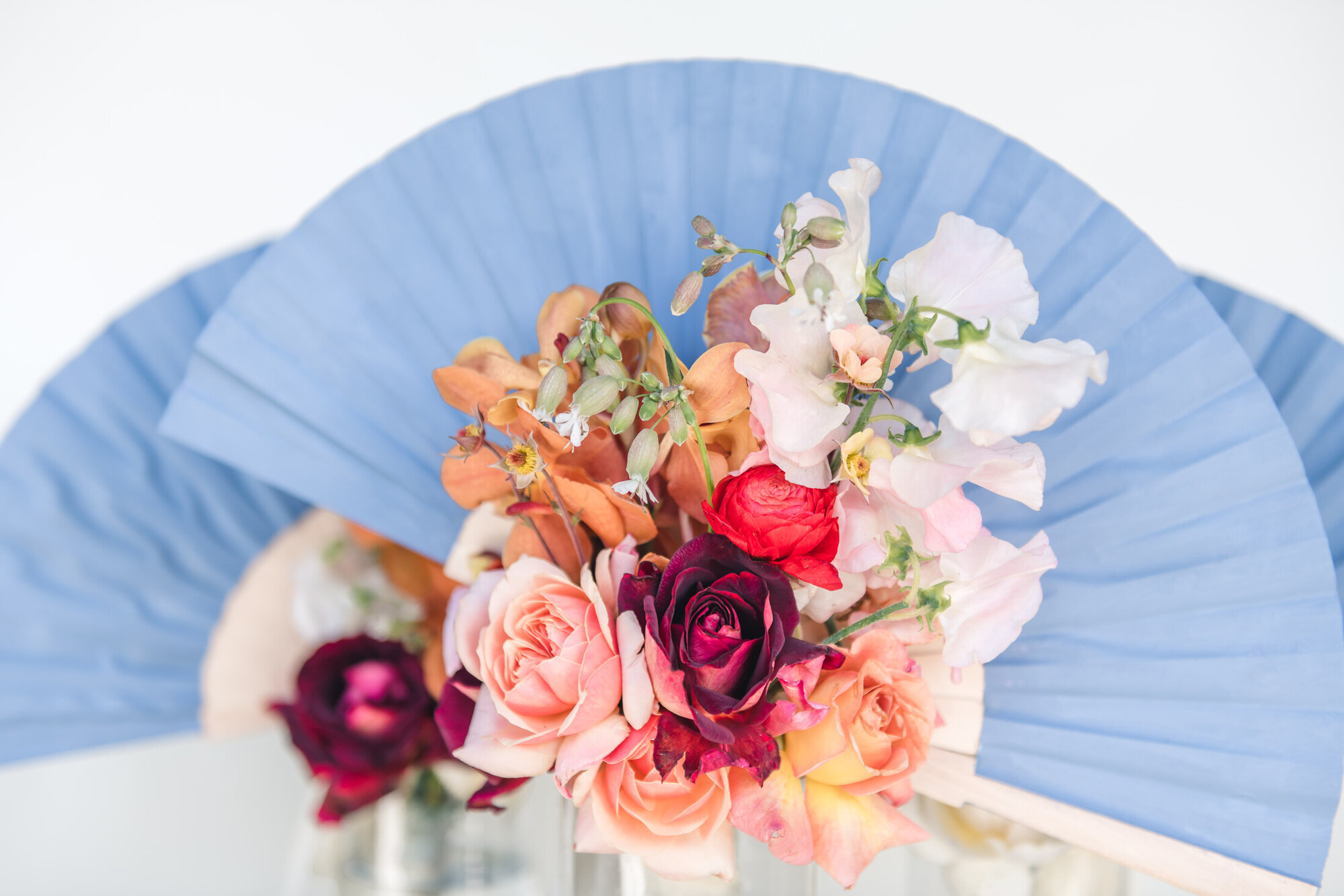 Blue fan and wedding bouquet detail