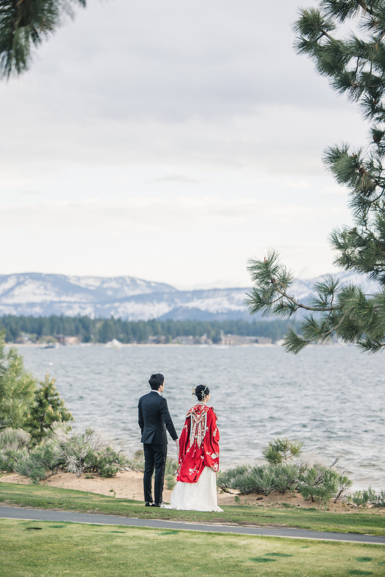 Couple in red Chinese wedding attire by Lake Tahoe
