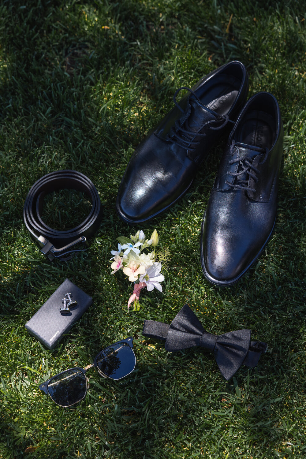 Groom details arranged on the grass