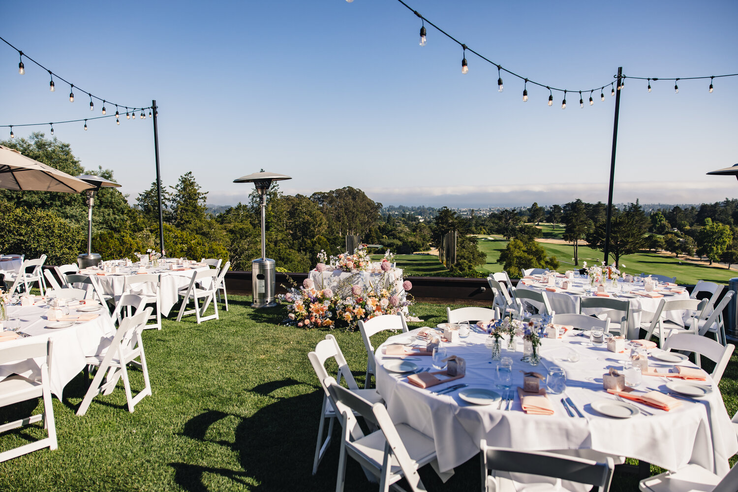 Reception lawn and dinner tables with hillside view