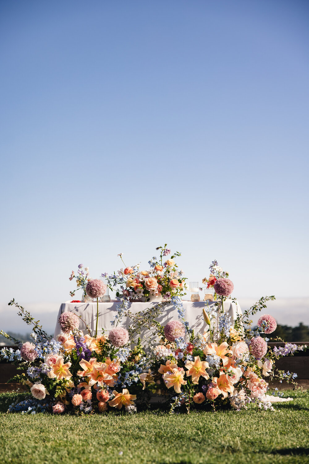 Reception flowers beneath a blue sky