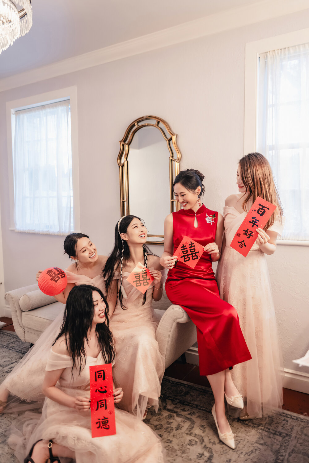 Bride in red dress with friends in the room