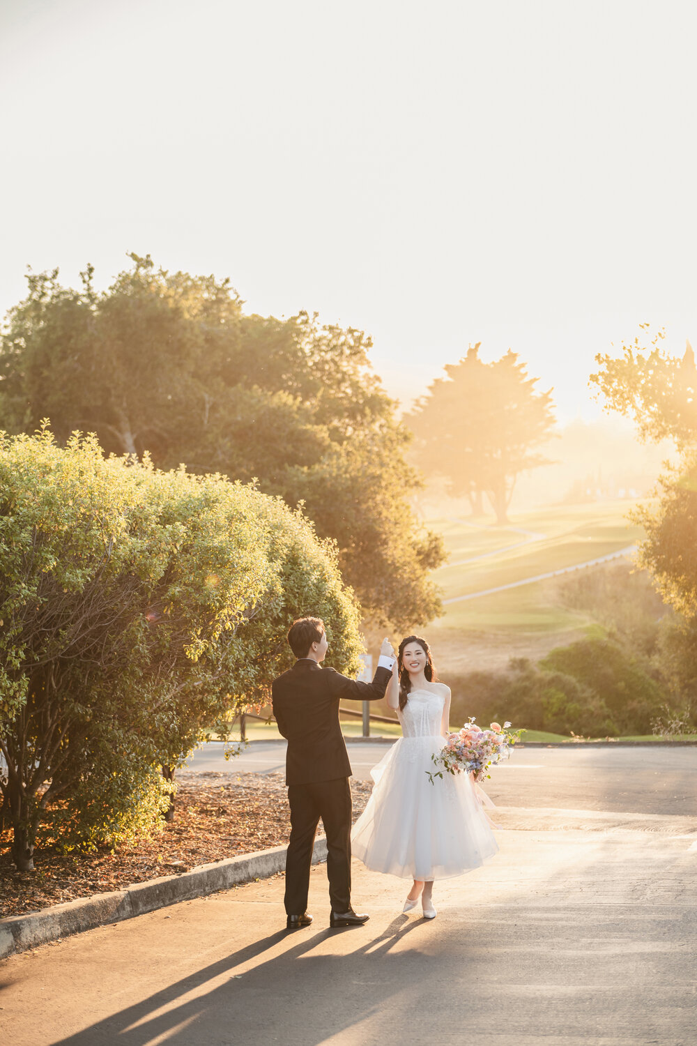 Couple walking through sunset hillside light