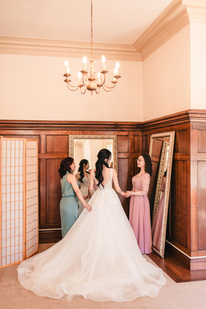 Bride with bridesmaids in the wood-paneled room
