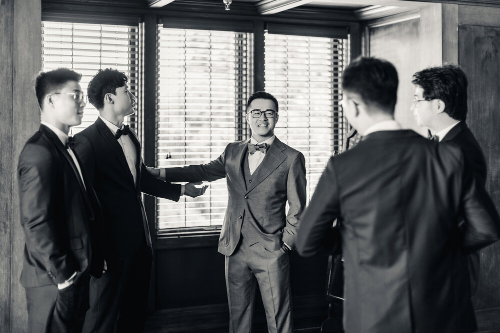 Black and white groom getting ready moment