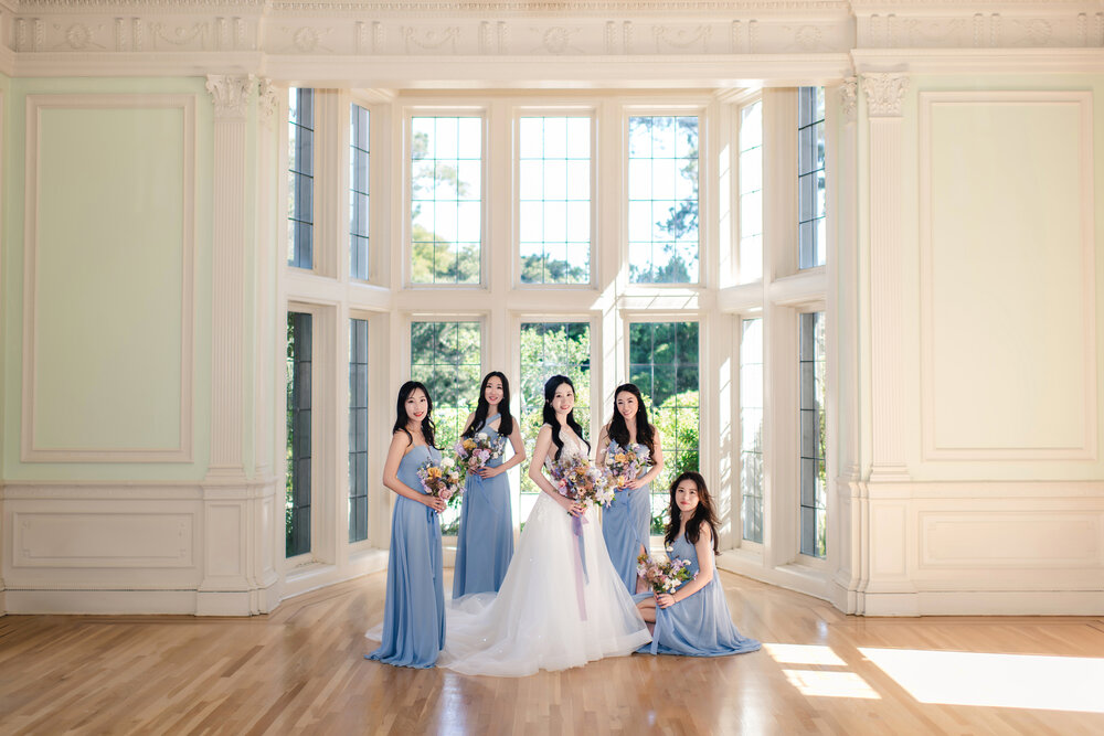 Bride and bridesmaids in a sunlit room