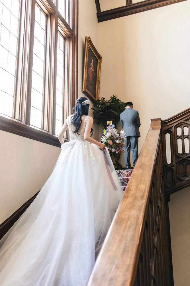 Bride walking through the staircase hall