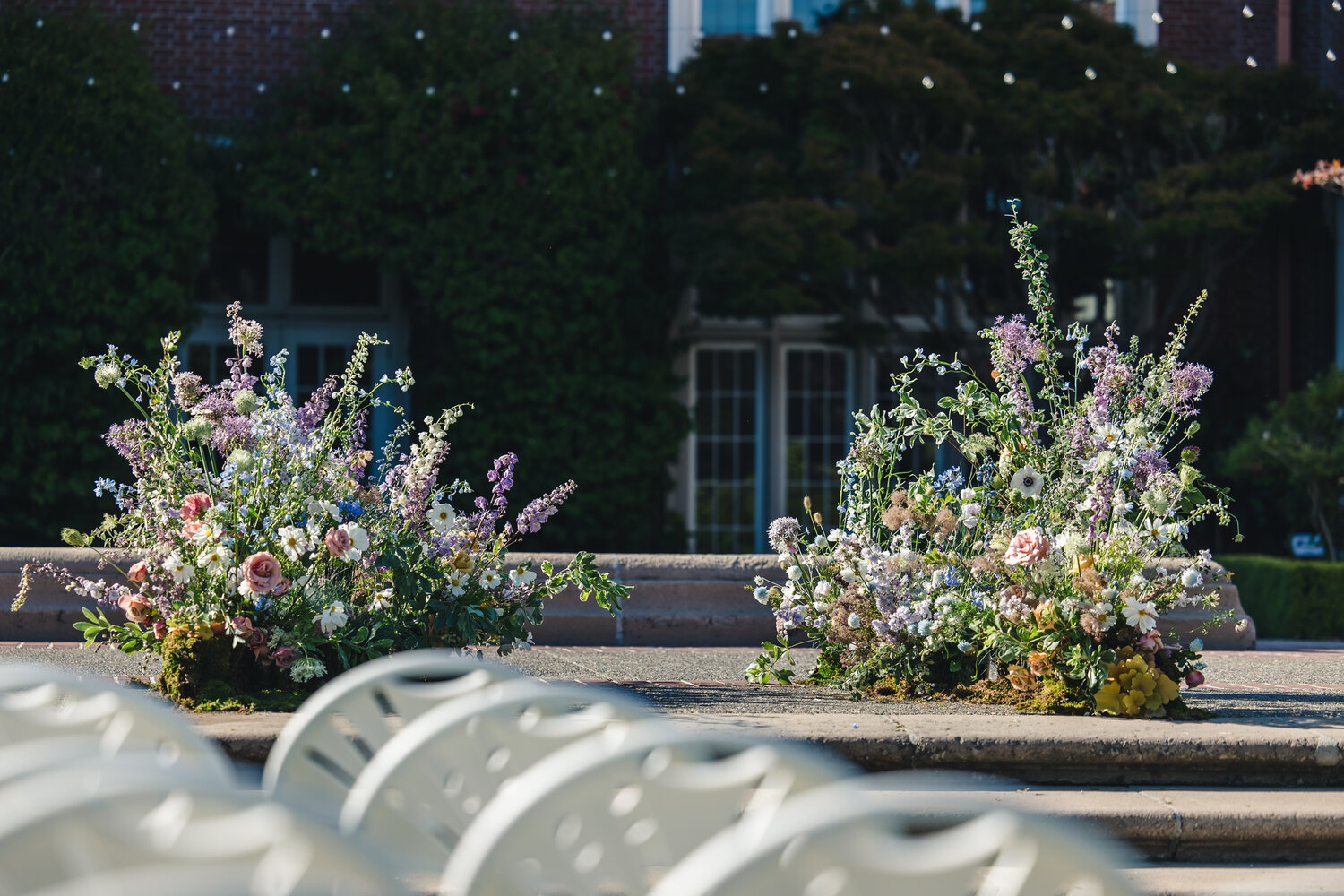 Garden ceremony aisle and floral arrangement