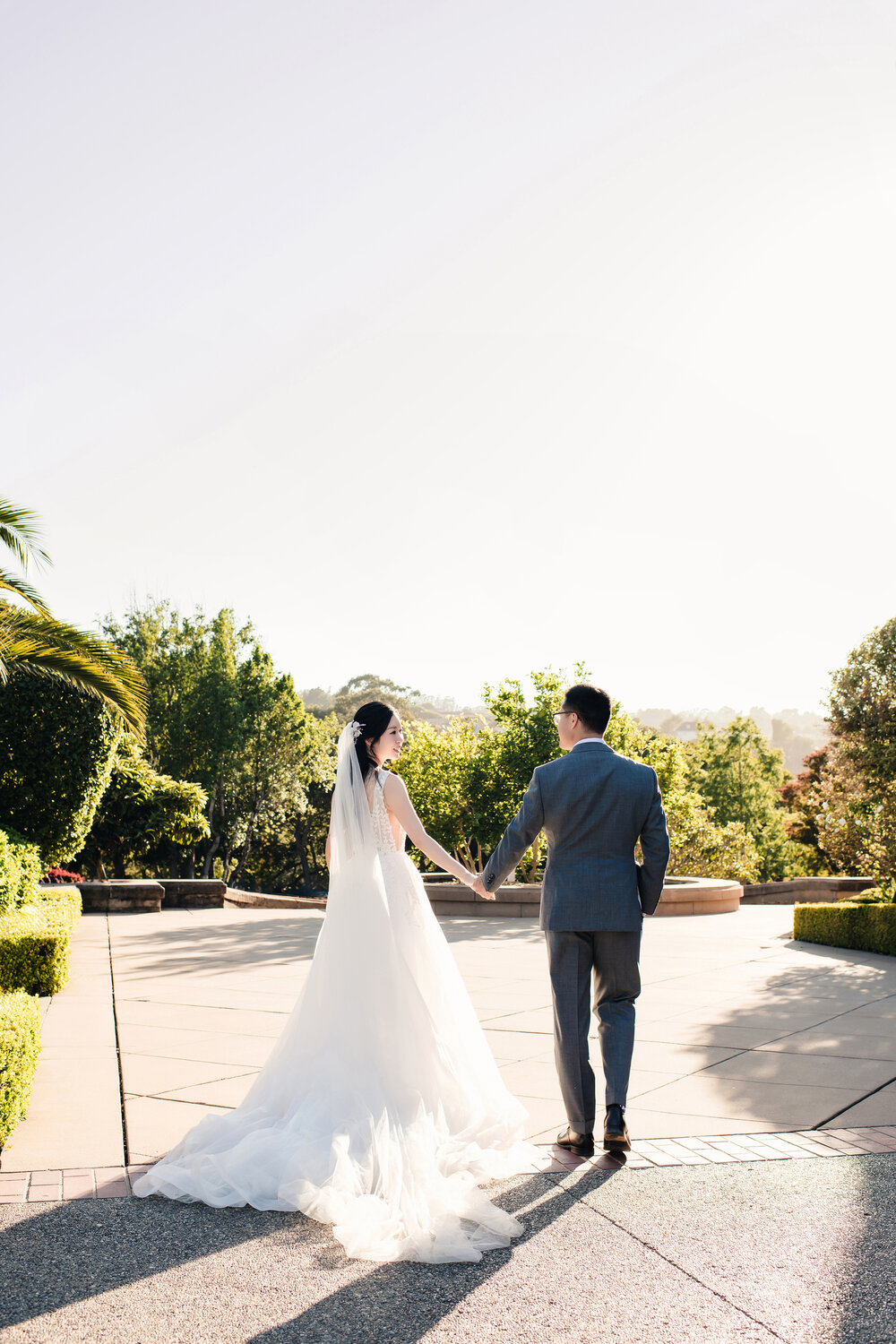 Couple walking through the garden after the ceremony