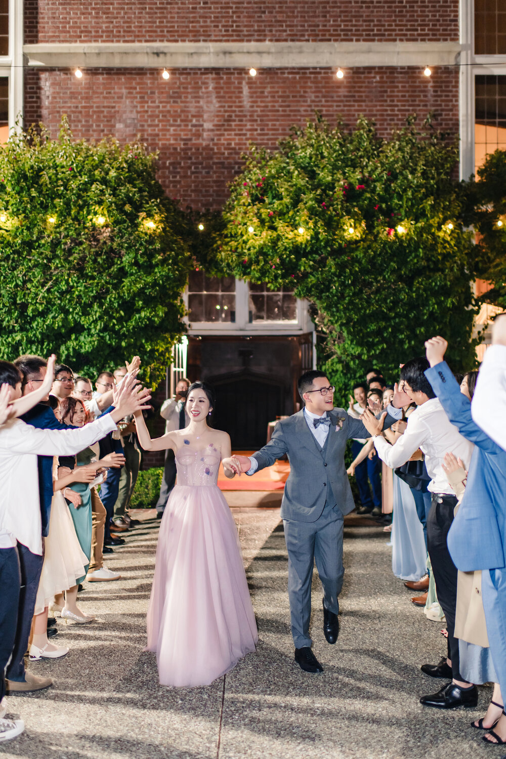 Couple walking through a sparkler exit