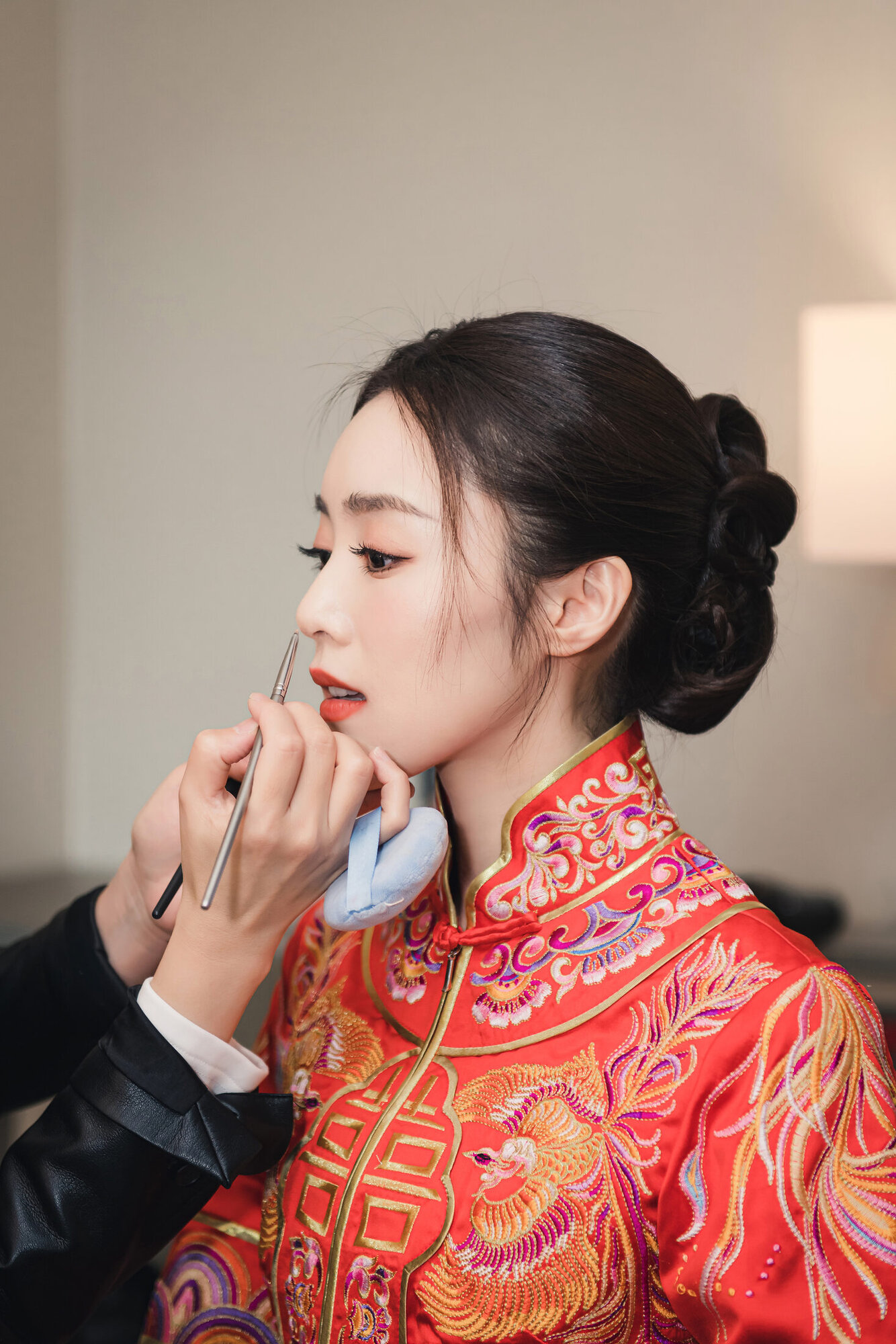 Bride getting ready in red dress