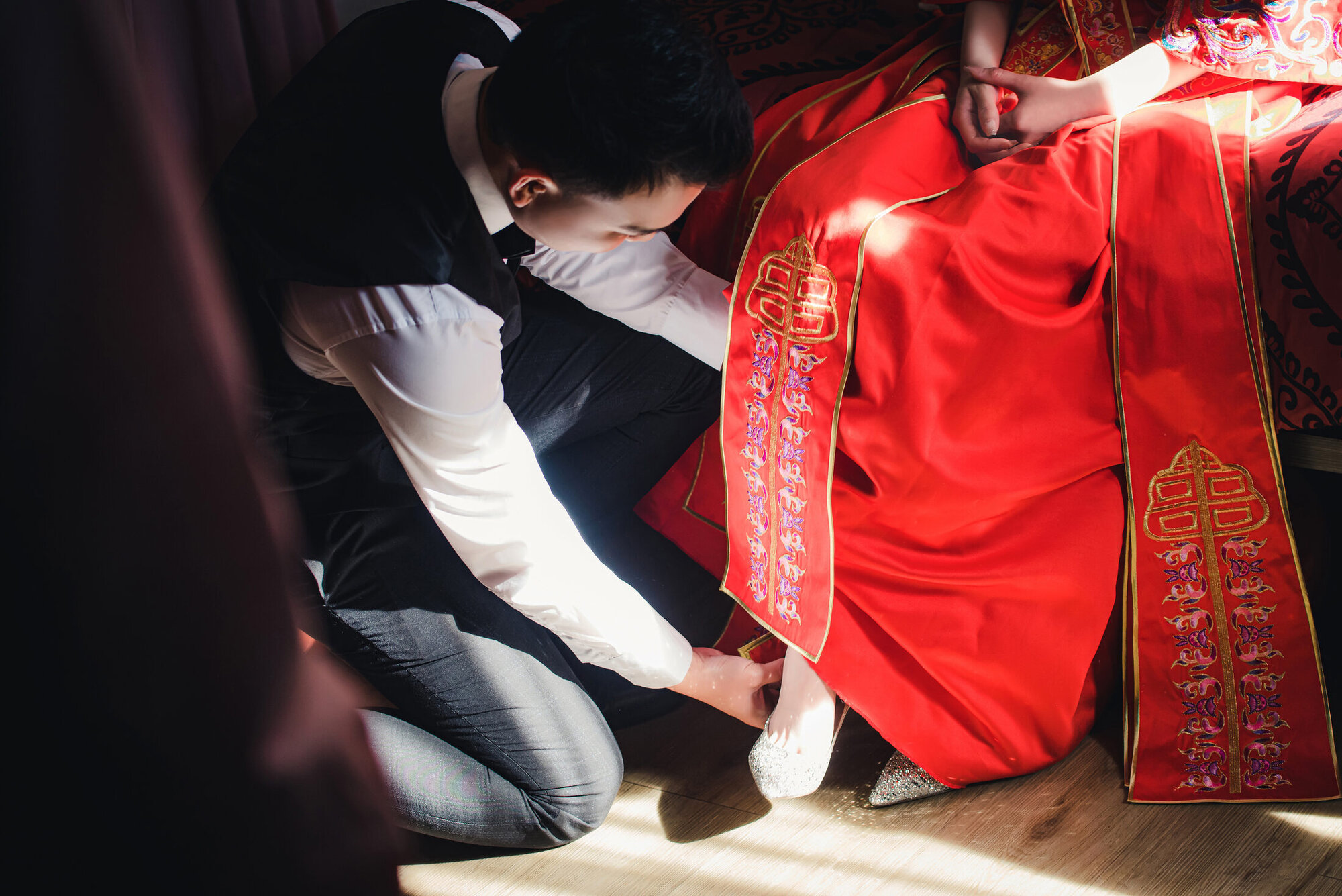 Groom kneeling during the wedding door game