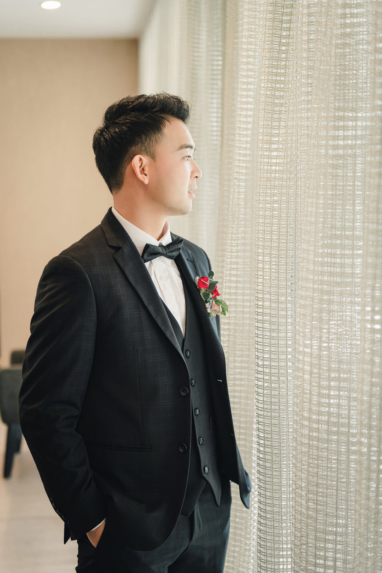 Groom portrait by the window