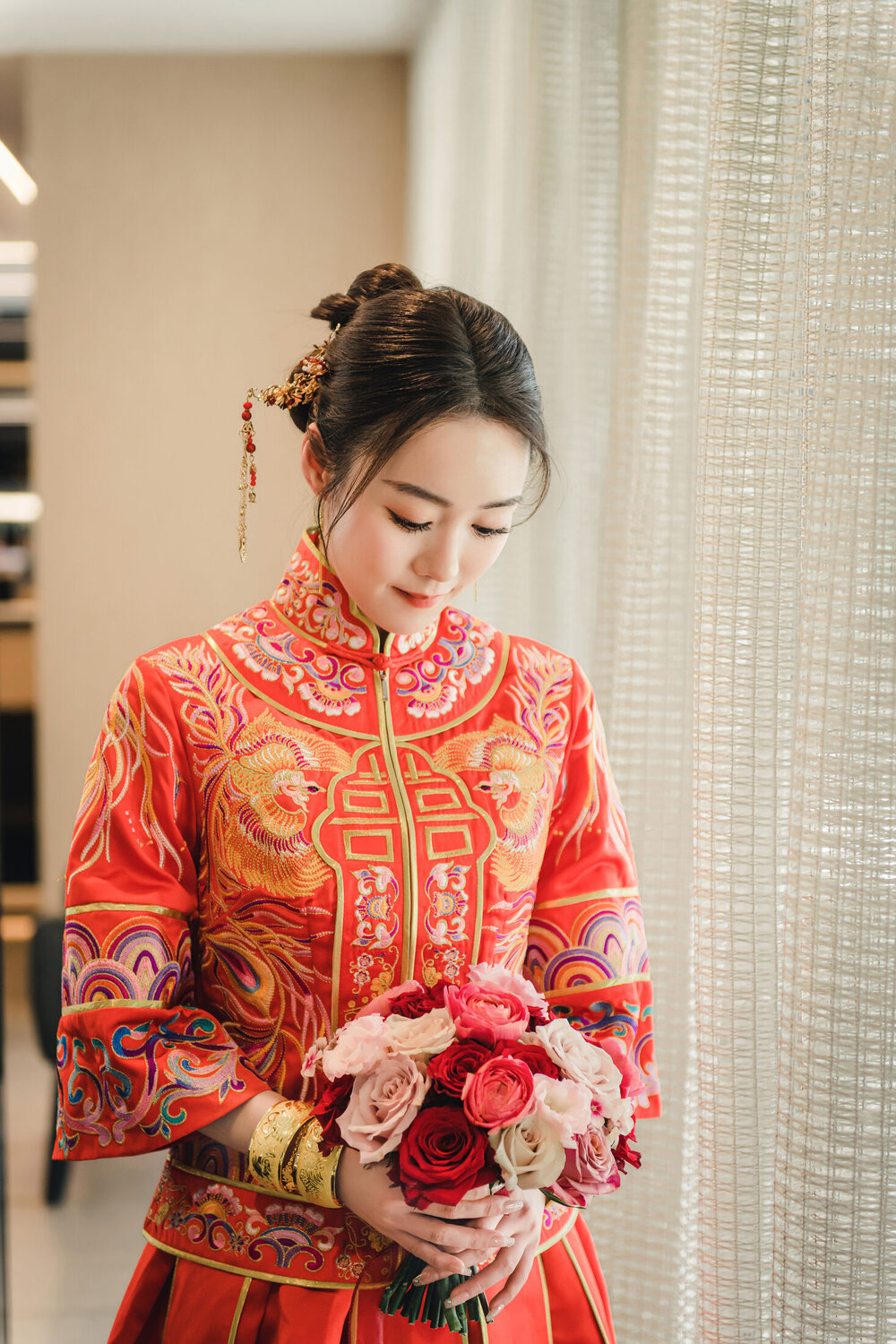 Bride in red holding her bouquet