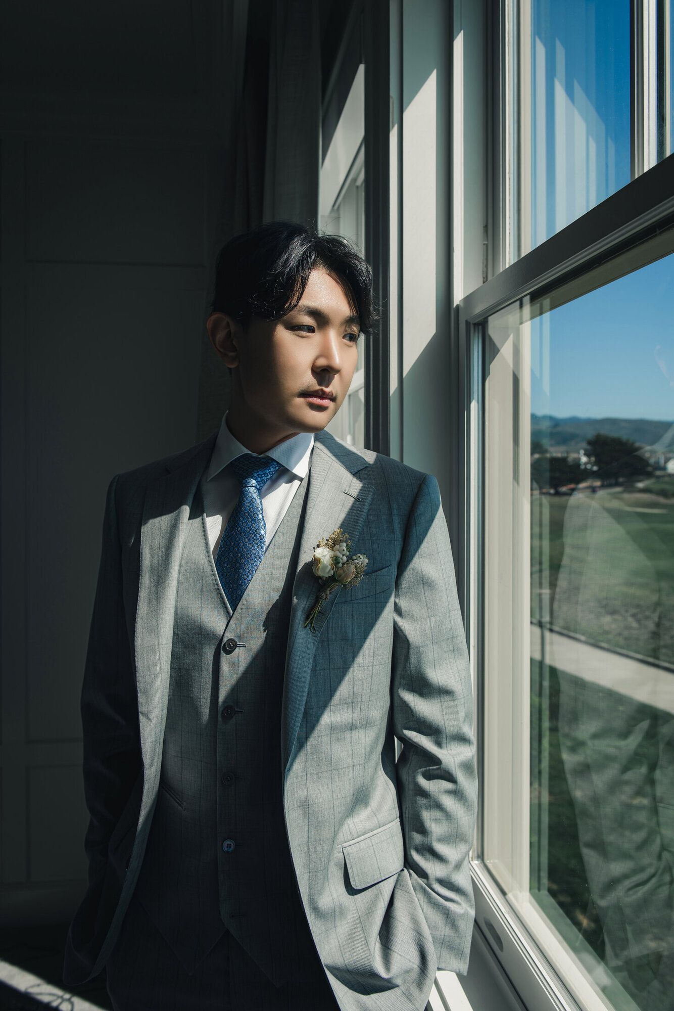 Groom portrait by the window