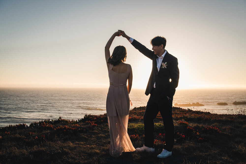 Couple dancing at sunset by the coast