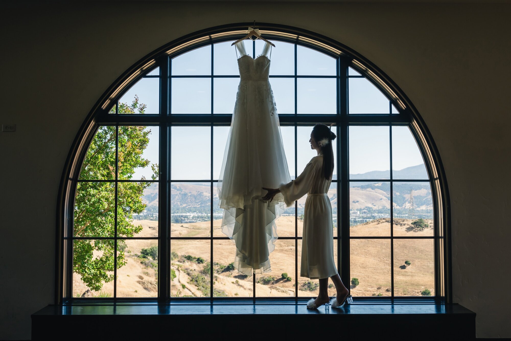 Wedding dress by the arched windows at The Ranch at Silver Creek