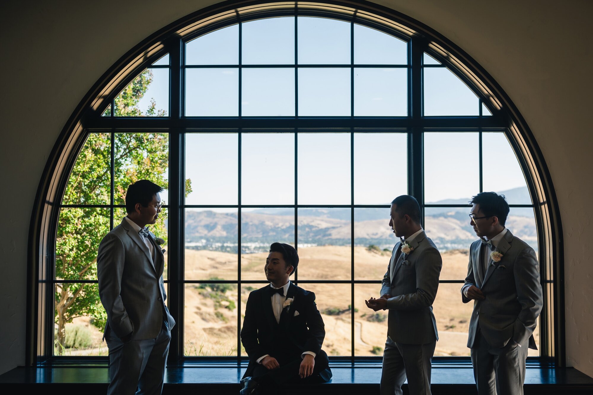 Groom and groomsmen by the window
