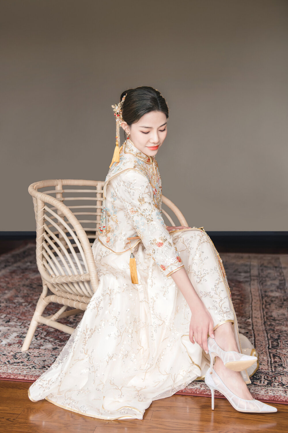 Bride in red Chinese wedding dress seated portrait