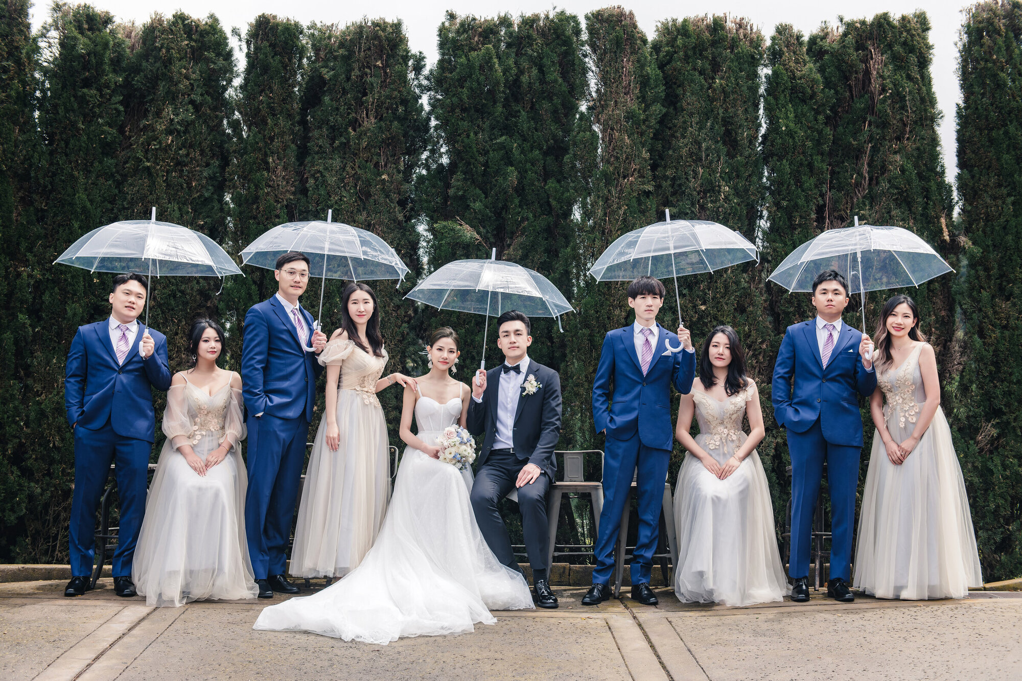 Bride under an umbrella with hillside views
