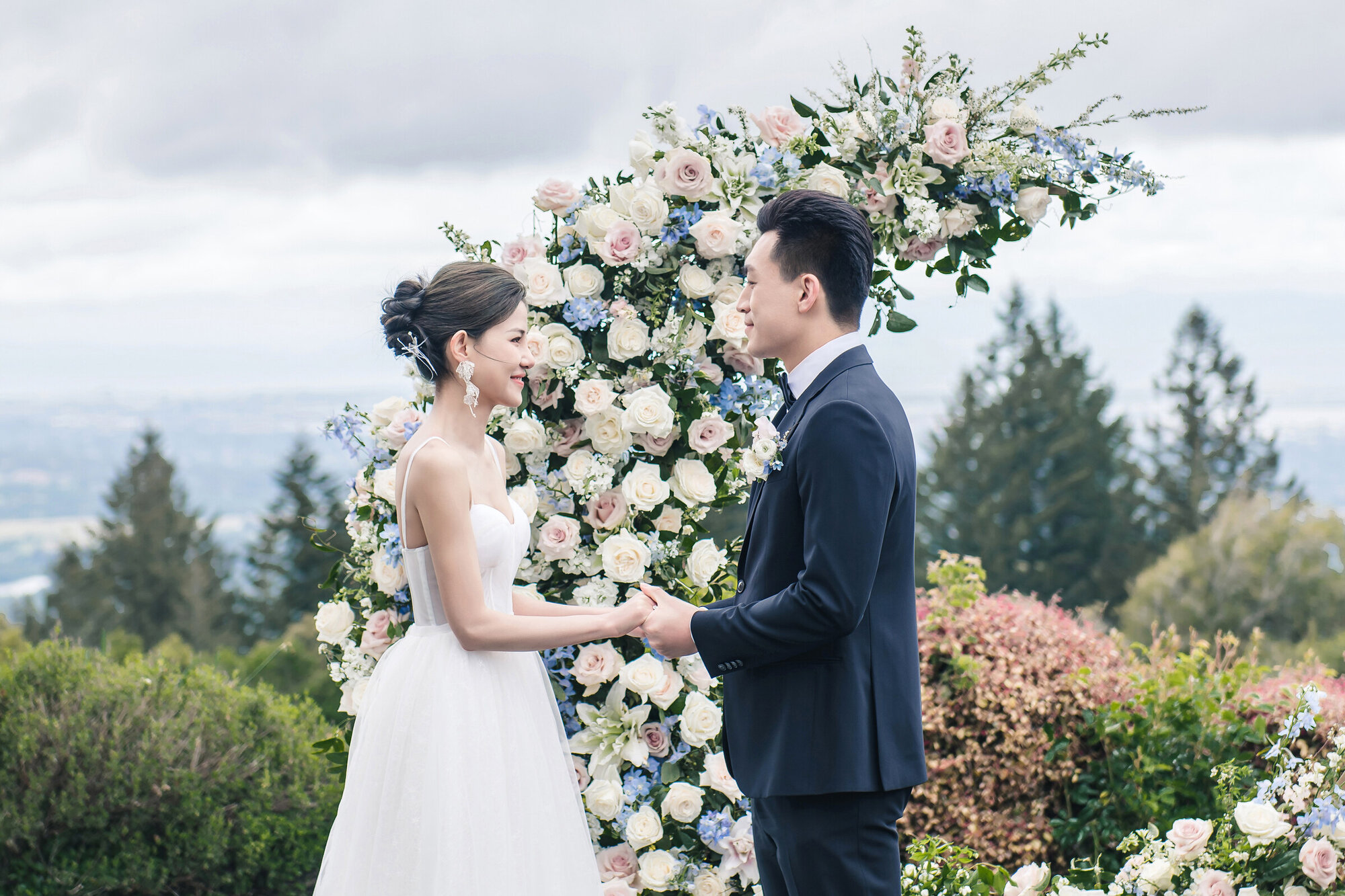 Couple at the floral ceremony arch