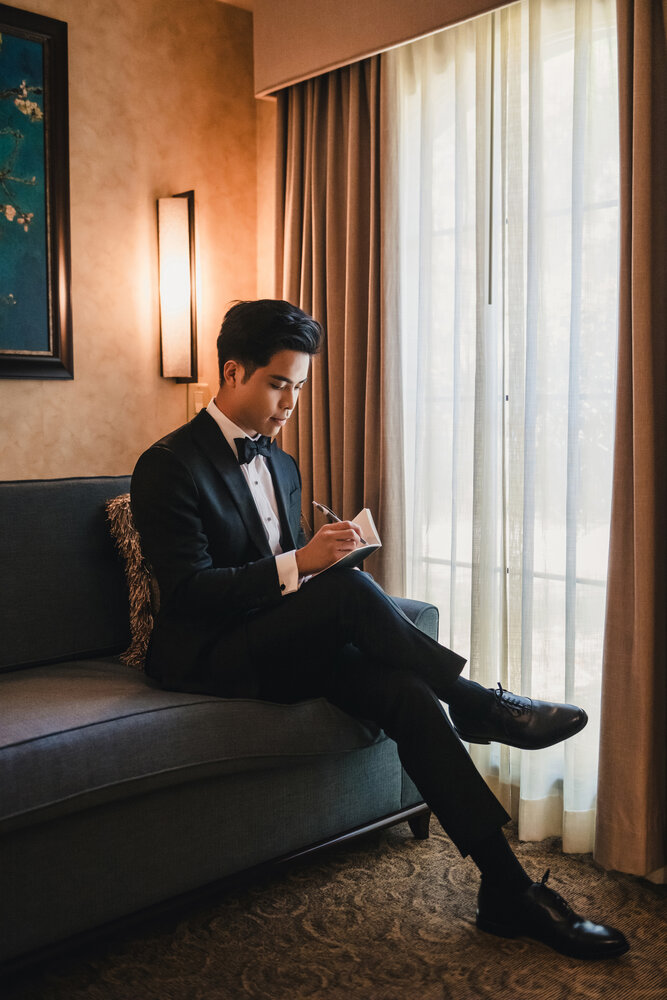 Groom getting ready by the window
