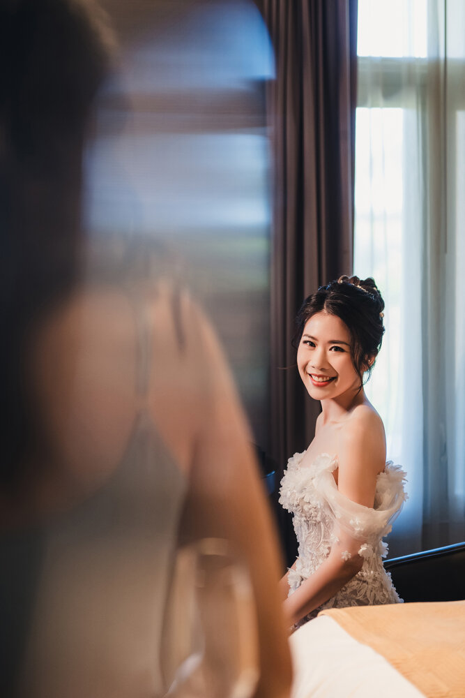 Bride smiling in window light