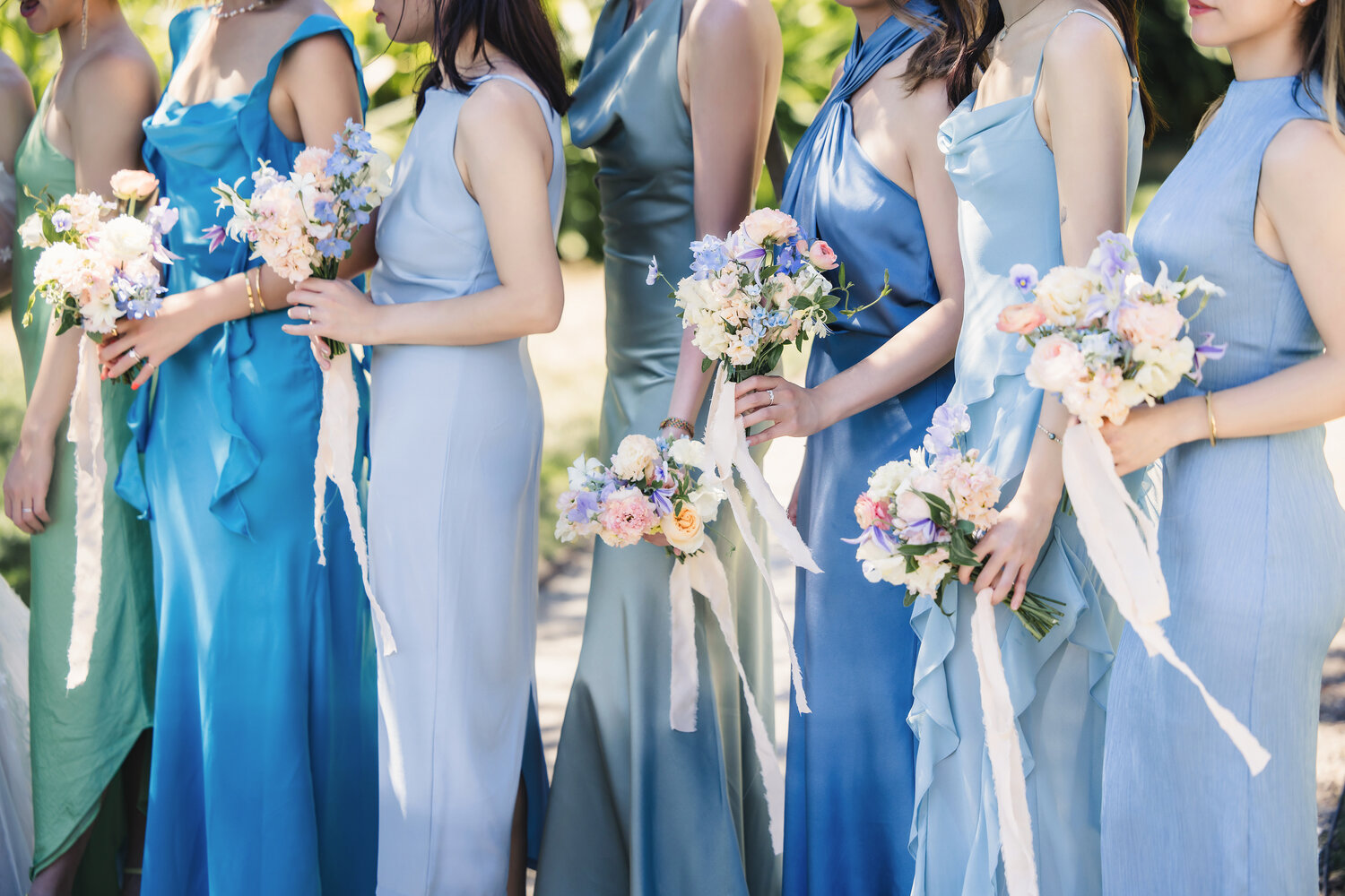 Bridesmaids holding pastel bouquets