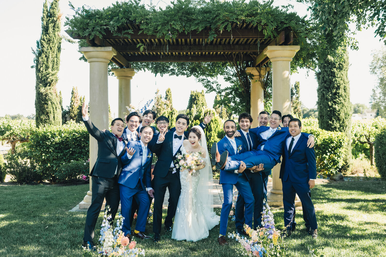 Wedding party beneath the ceremony arch