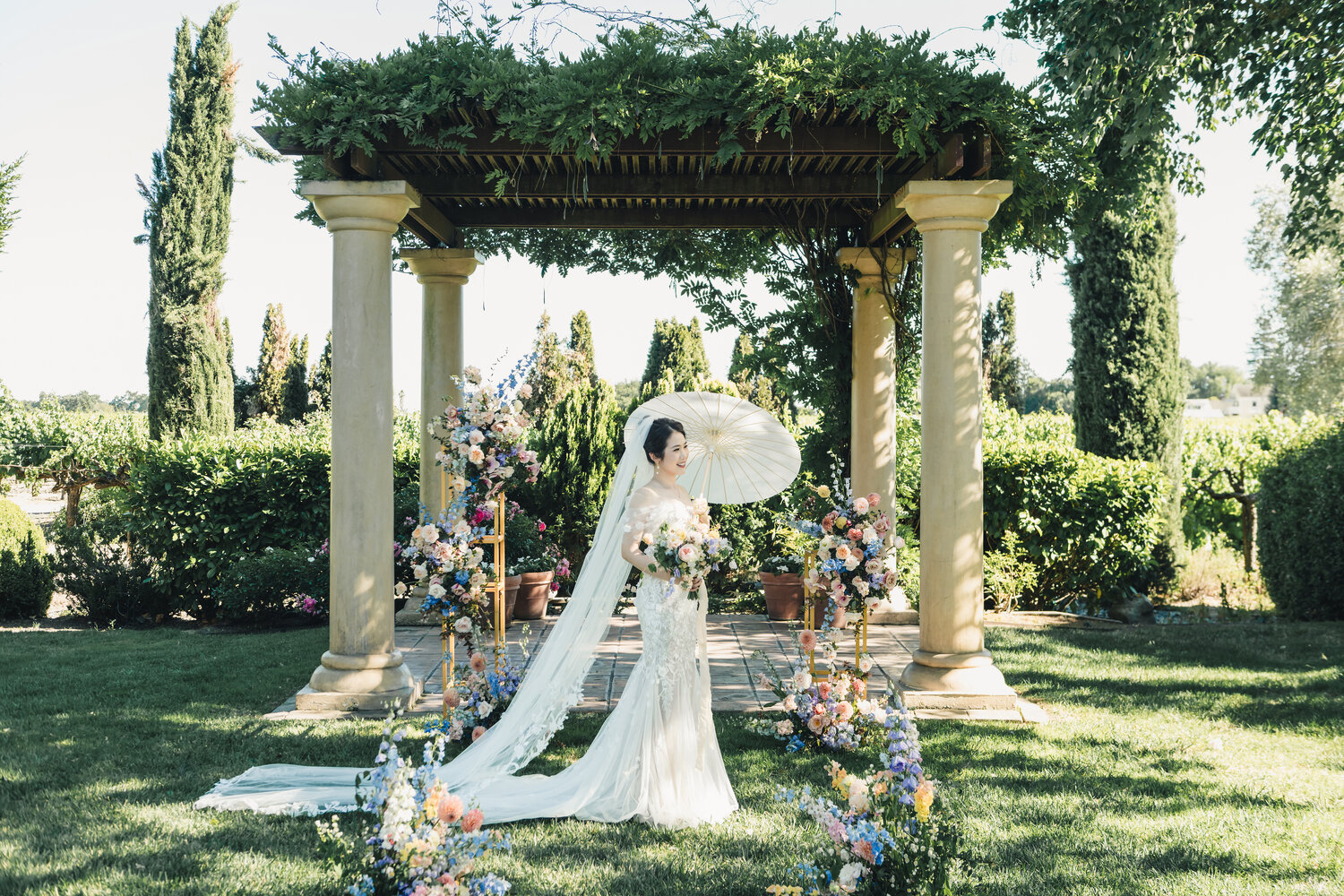 Couple portrait with parasols in the garden