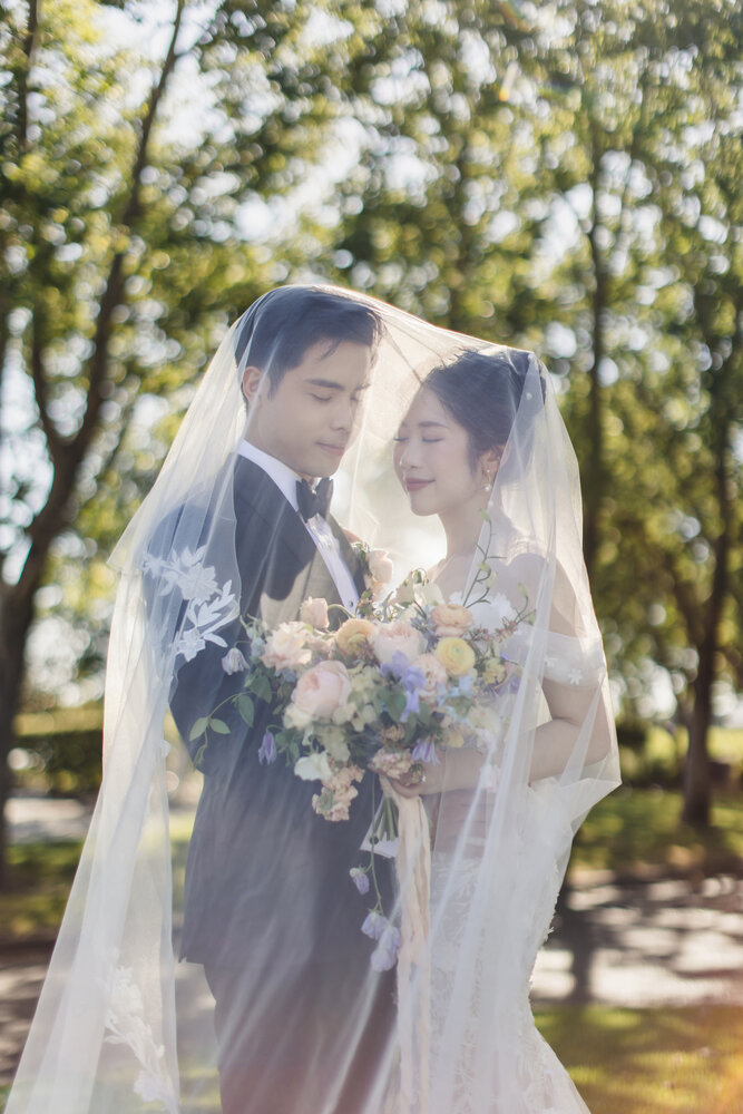 Couple portrait through the veil